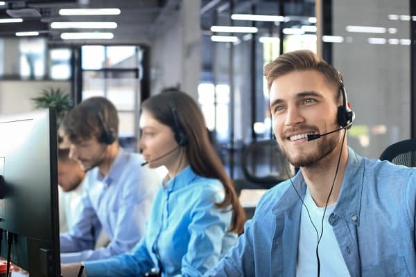 Man in office supporting customer